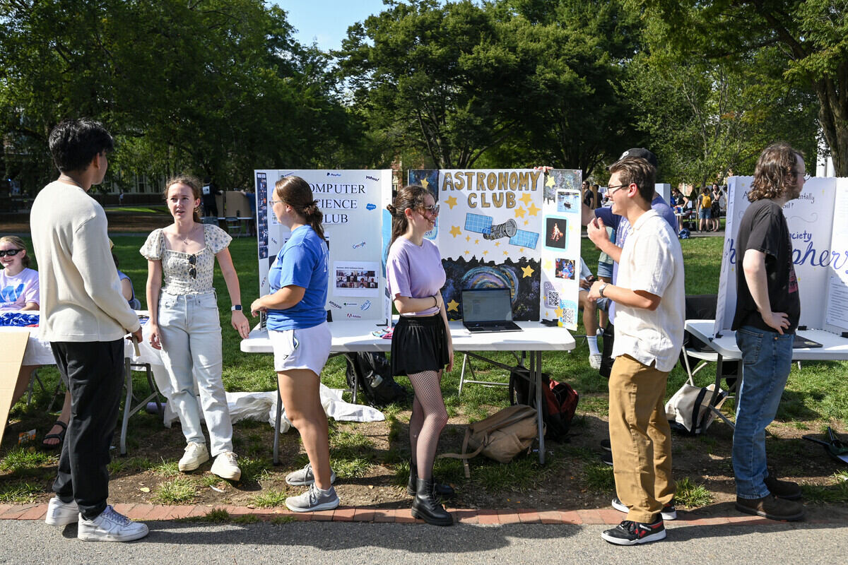 A student club talks to admitted students at Lyons Fest on Welcome to Wheaton Day