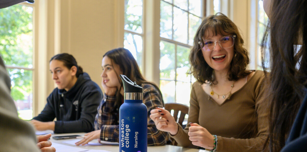 Students laughing and thoughtfully engaged in conversation